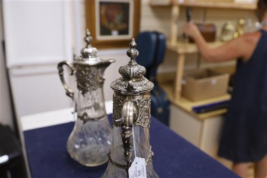 A pair of 19th century German 800 white metal mounted glass claret jugs,